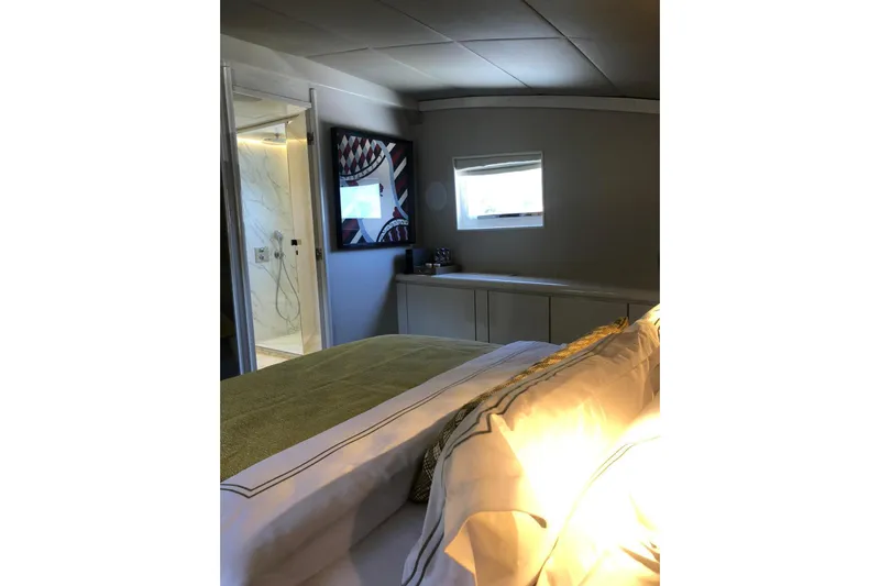 Axella Yacht Photos Pics Luxurious bedroom interior on 1991 Crestitalia 33m yacht with modern decor and natural lighting.