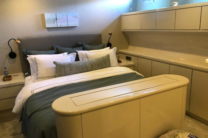 Axella Yacht Photos Pics Luxurious bedroom interior on a 1991 Crestitalia 33m yacht, featuring elegant bedding and modern cabinetry.