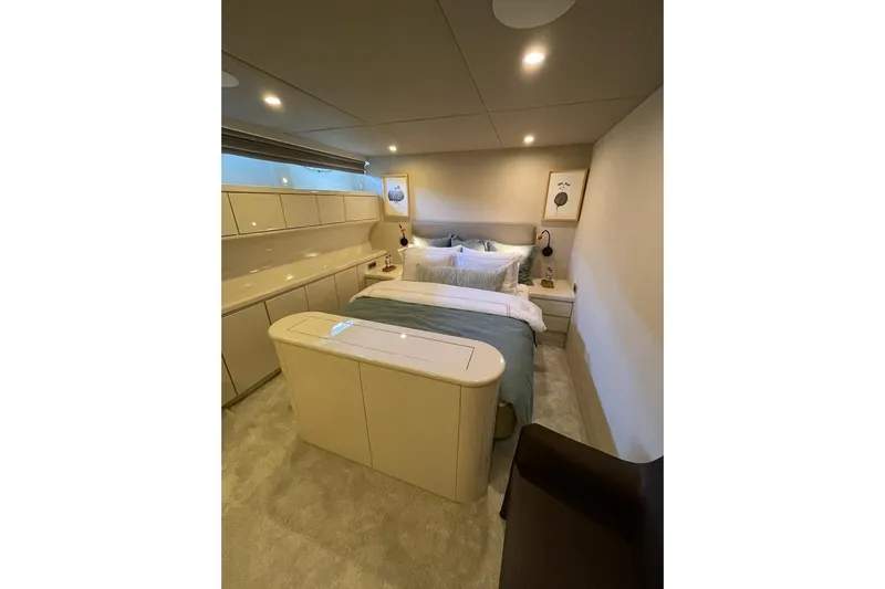 Axella Yacht Photos Pics Luxurious bedroom interior on 1991 Crestitalia 33m yacht, featuring modern design and cozy ambiance.