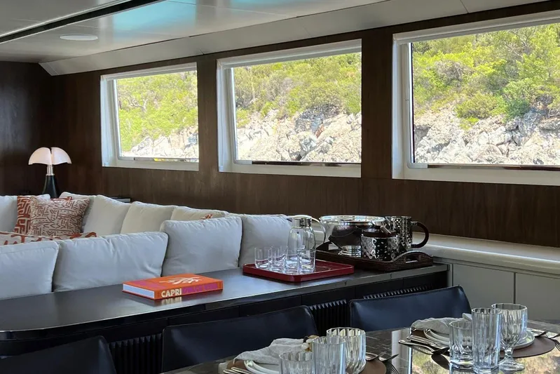 Axella Yacht Photos Pics Luxurious interior of 1991 Crestitalia 33m yacht with elegant dining setup and scenic views.