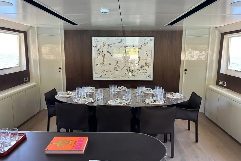 Axella Yacht Photos Pics Luxurious dining area on a 1991 Crestitalia 33m yacht, featuring elegant table settings and modern decor.