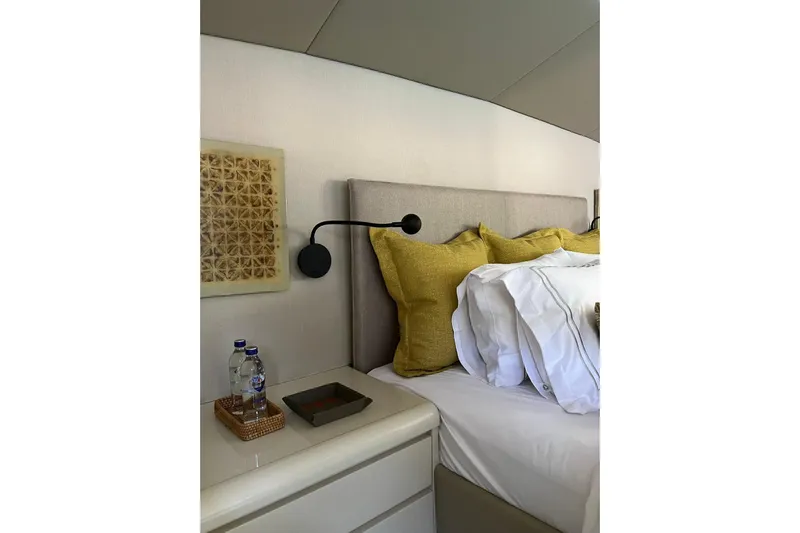Axella Yacht Photos Pics Luxurious bedroom interior on 1991 Crestitalia 33m yacht with modern decor and cozy bedding.