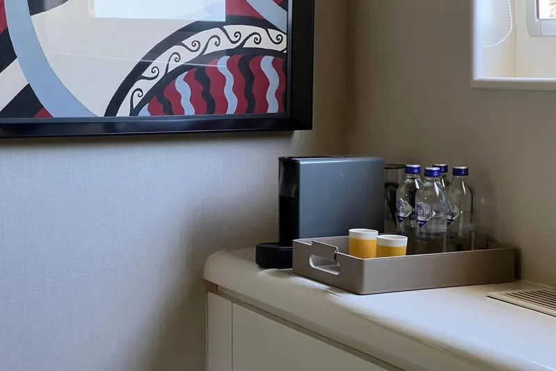 Axella Yacht Photos Pics Interior of Crestitalia 33m yacht, featuring a modern art piece and a refreshment tray.