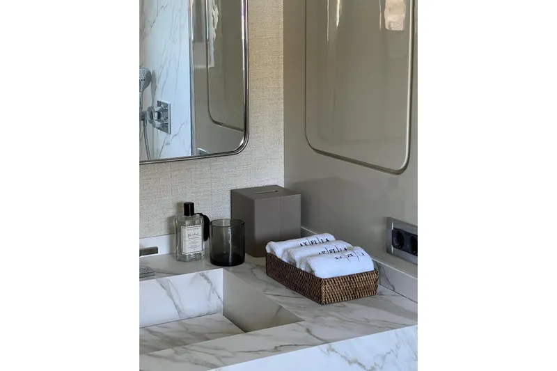 Axella Yacht Photos Pics Luxurious bathroom vanity with marble countertop, mirror, and toiletries on a Crestitalia 33m yacht.