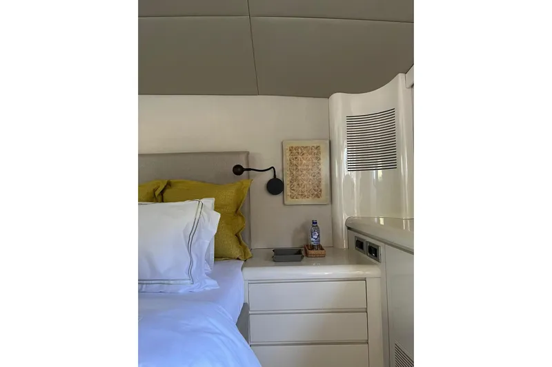 Axella Yacht Photos Pics Luxurious bedroom interior of 1991 Crestitalia 33m yacht with modern decor and cozy bedding.