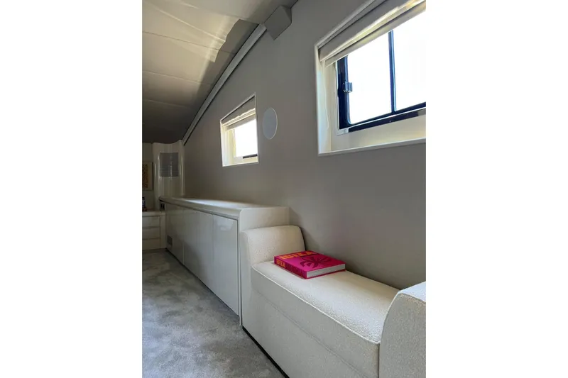 Axella Yacht Photos Pics Luxurious interior of 1991 Crestitalia 33m yacht with modern seating and a book.