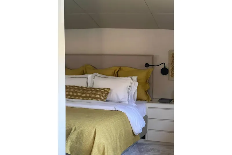 Axella Yacht Photos Pics Luxurious bedroom with yellow bedding on a Crestitalia 33m yacht, 1991 model.