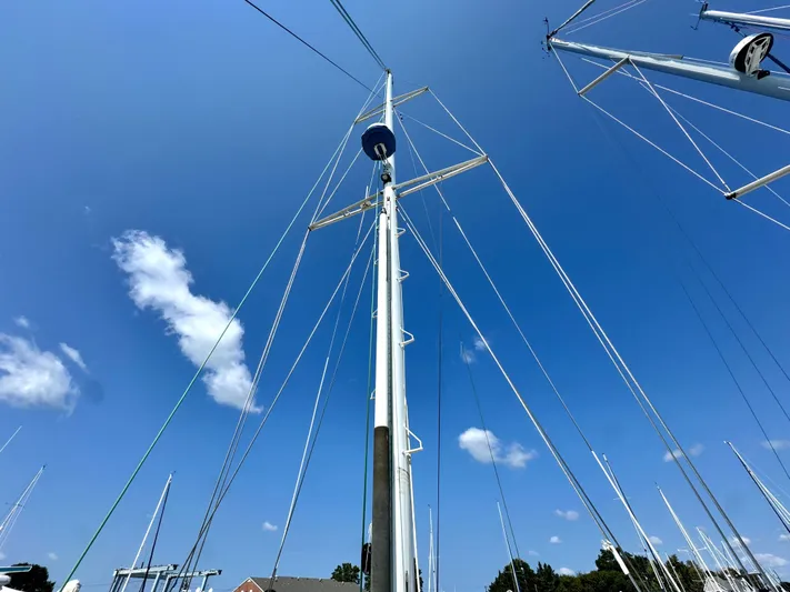 Tack Yacht Photos Pics Mast of a 1999 Bowman 48 Aft Cockpit sailboat under blue sky.