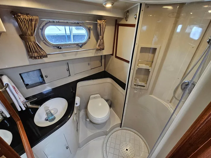 Journey Yacht Photos Pics Luxurious 2007 Grand Banks 39 Eastbay SX yacht bathroom with shower and porthole window.