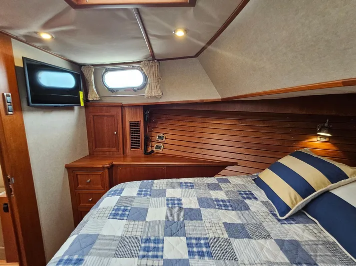 Journey Yacht Photos Pics Cozy cabin interior of 2007 Grand Banks 39 Eastbay SX with bed and TV.