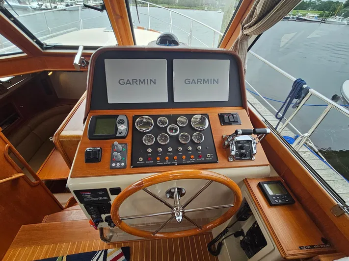 Journey Yacht Photos Pics 2007 Grand Banks 39 Eastbay SX helm with Garmin navigation displays and classic wooden steering wheel.