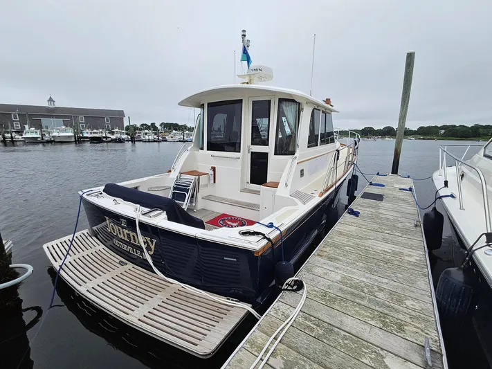 Journey Yacht Photos Pics 2007 Grand Banks 39 Eastbay SX docked at marina, rear view.
