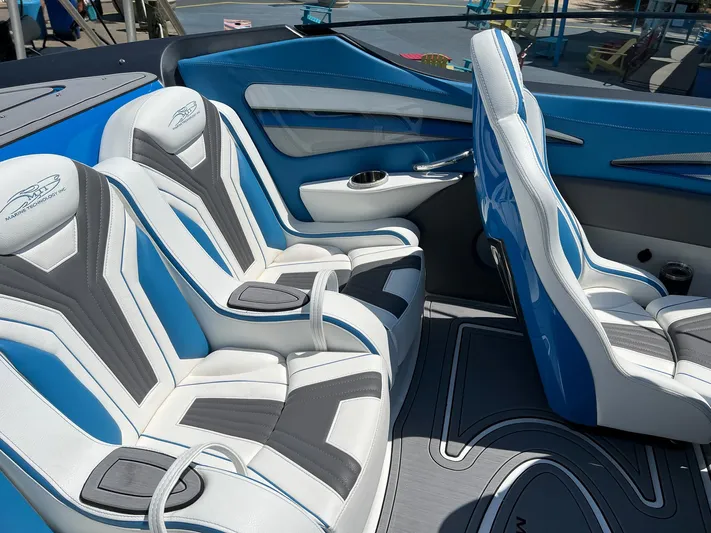 El Gato Yacht Photos Pics Luxury interior of 2022 MTI 390X boat with blue and white seating.