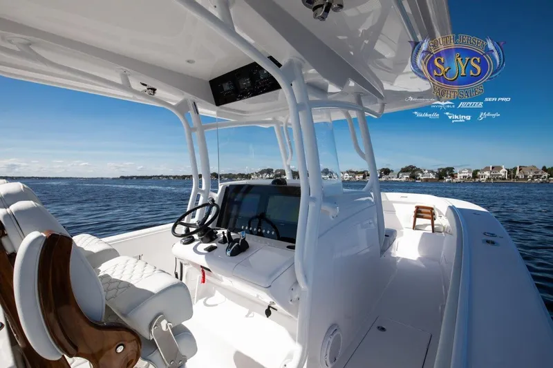  Yacht Photos Pics 2024 Jupiter 34 boat interior with steering wheel and navigation system.