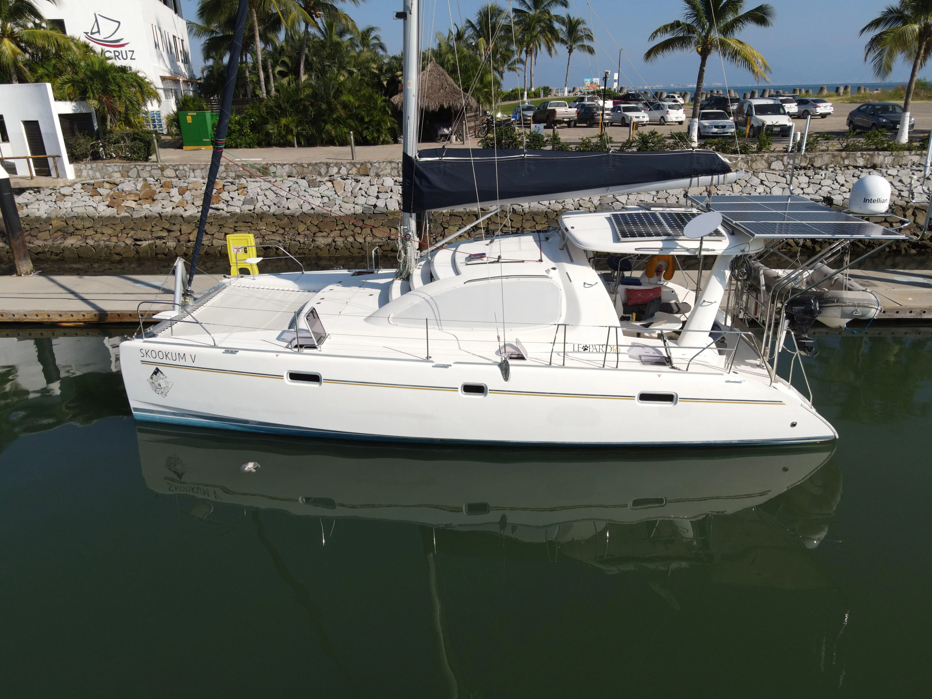  Yacht Photos Pics 2010 Leopard 40 catamaran docked at marina with solar panels and palm trees in background.