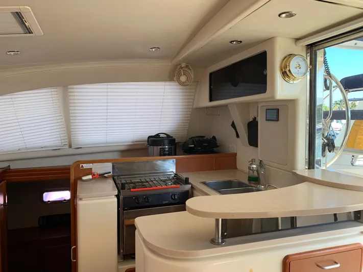  Yacht Photos Pics Interior of 2010 Leopard 40 yacht featuring a compact kitchen with stove and sink.