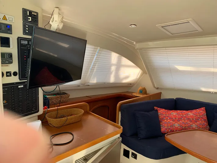  Yacht Photos Pics Interior of 2010 Leopard 40 yacht with cozy seating, TV, and control panel.