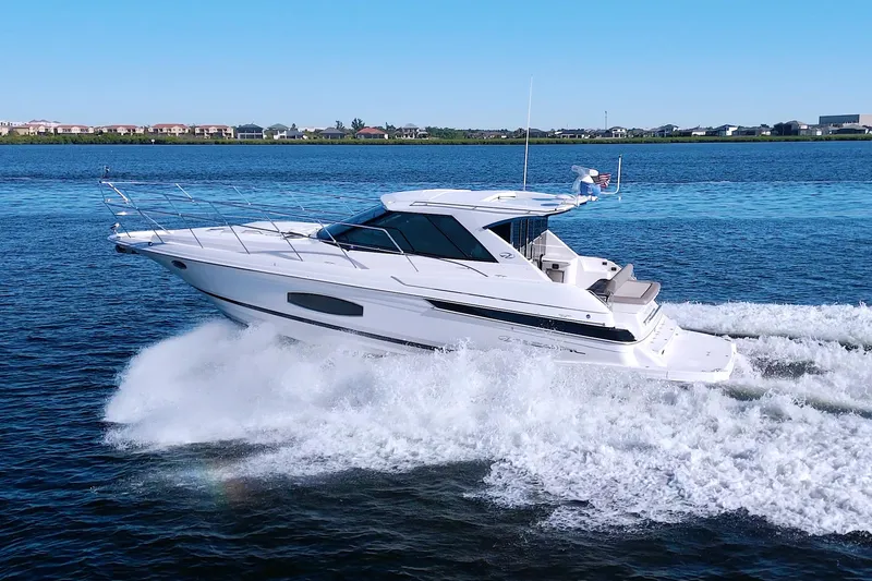 Serenity In The Sea Yacht Photos Pics 2014 Regal 46 Sport Coupe cruising on open water, showcasing sleek design and performance.