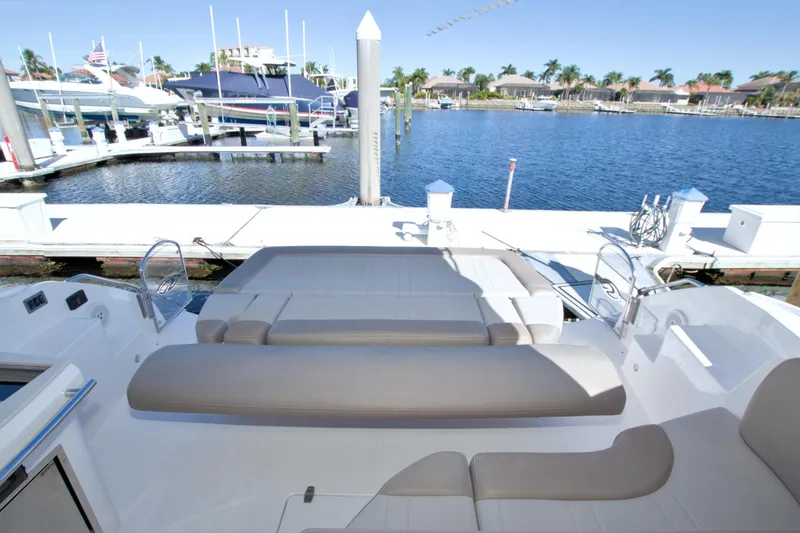 Serenity In The Sea Yacht Photos Pics 2014 Regal 46 Sport Coupe yacht at marina, featuring spacious sun deck and waterfront view.