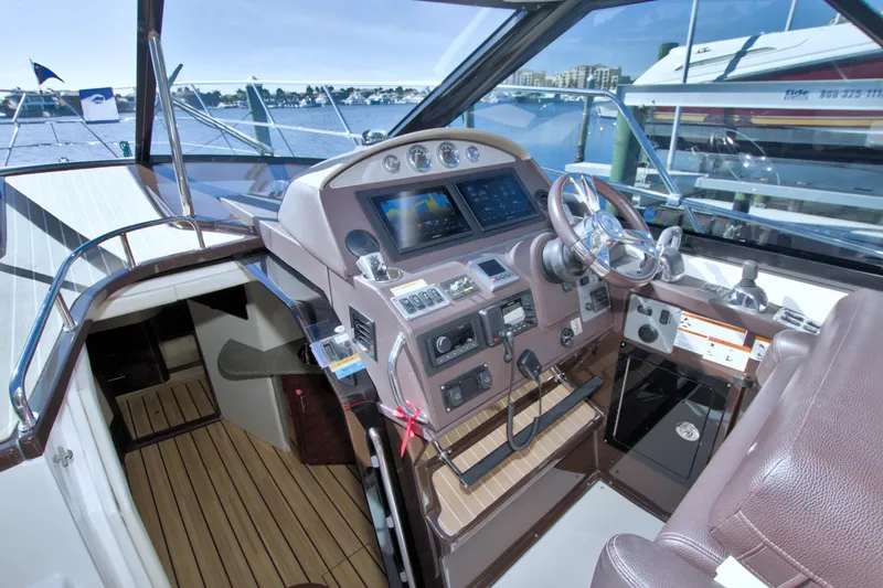 Serenity In The Sea Yacht Photos Pics 2014 Regal 46 Sport Coupe helm with modern controls and waterfront view.
