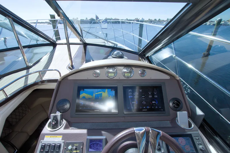 Serenity In The Sea Yacht Photos Pics Helm of 2014 Regal 46 Sport Coupe with navigation screens and controls.