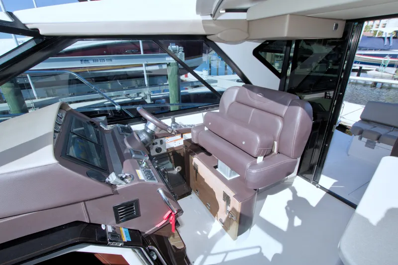 Serenity In The Sea Yacht Photos Pics 2014 Regal 46 Sport Coupe helm with leather seating and modern controls.