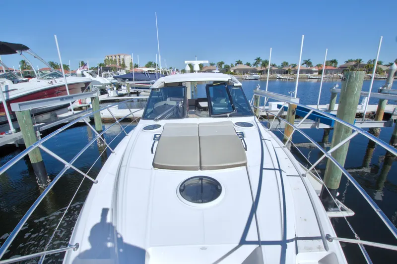 Serenity In The Sea Yacht Photos Pics 2014 Regal 46 Sport Coupe yacht docked at marina under clear blue sky.