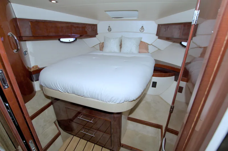 Serenity In The Sea Yacht Photos Pics Luxurious cabin interior of 2014 Regal 46 Sport Coupe with elegant wood finishes.