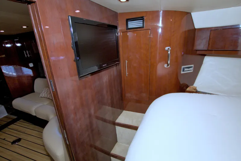 Serenity In The Sea Yacht Photos Pics Interior of 2014 Regal 46 Sport Coupe with wood paneling and flat-screen TV.