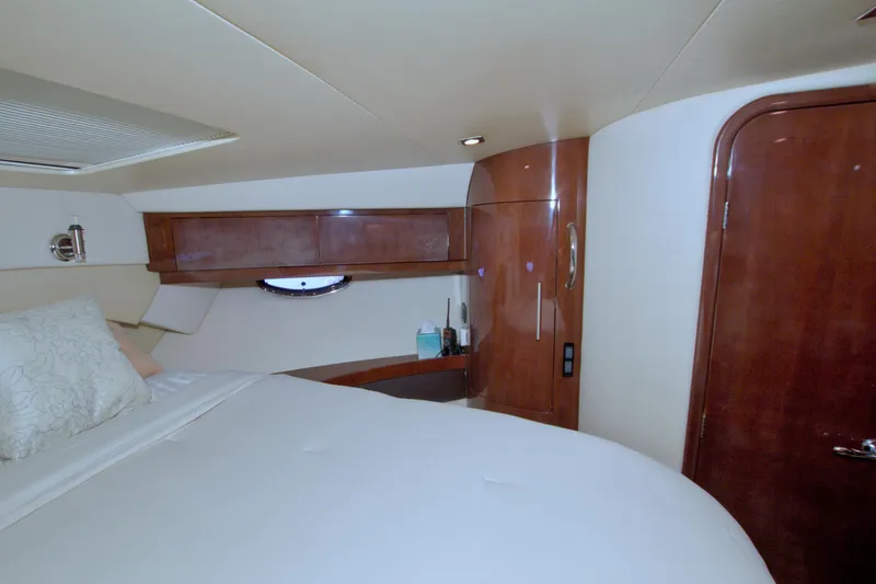 Serenity In The Sea Yacht Photos Pics Luxurious cabin interior of 2014 Regal 46 Sport Coupe yacht with wood finishes.