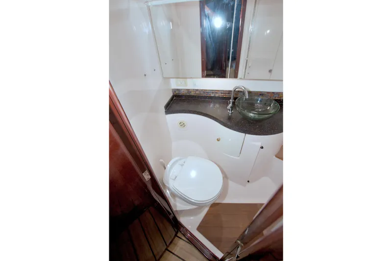 Serenity In The Sea Yacht Photos Pics 2014 Regal 46 Sport Coupe bathroom with modern sink and toilet.