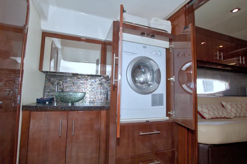 Serenity In The Sea Yacht Photos Pics 2014 Regal 46 Sport Coupe interior with washer, sink, and modern cabinetry.
