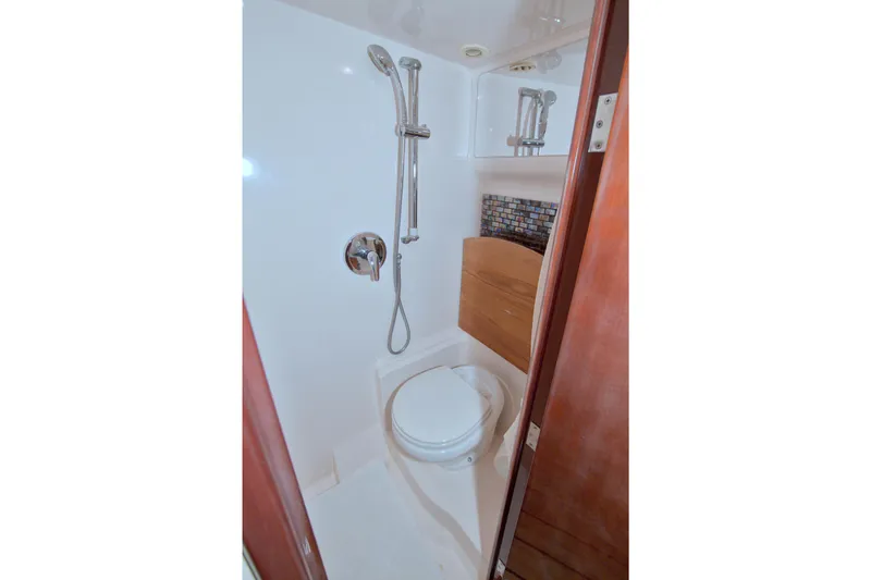 Serenity In The Sea Yacht Photos Pics 2014 Regal 46 Sport Coupe bathroom with shower and toilet.