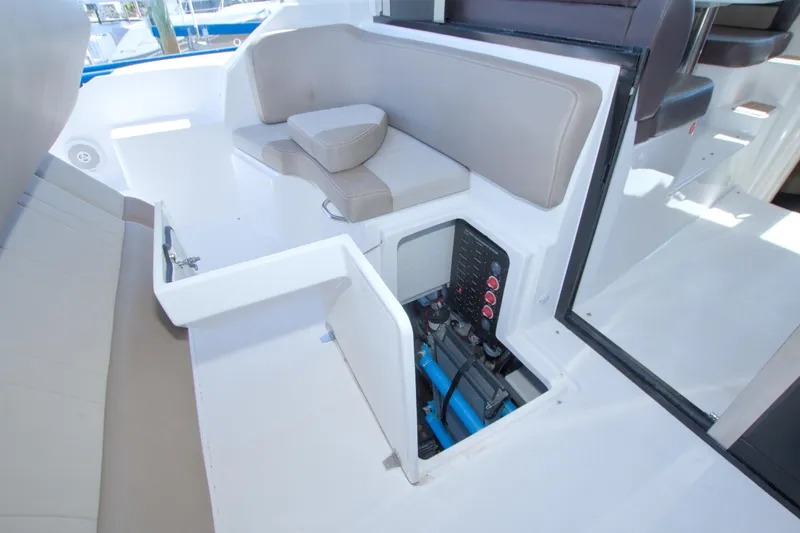 Serenity In The Sea Yacht Photos Pics 2014 Regal 46 Sport Coupe interior with seating and open storage compartment.