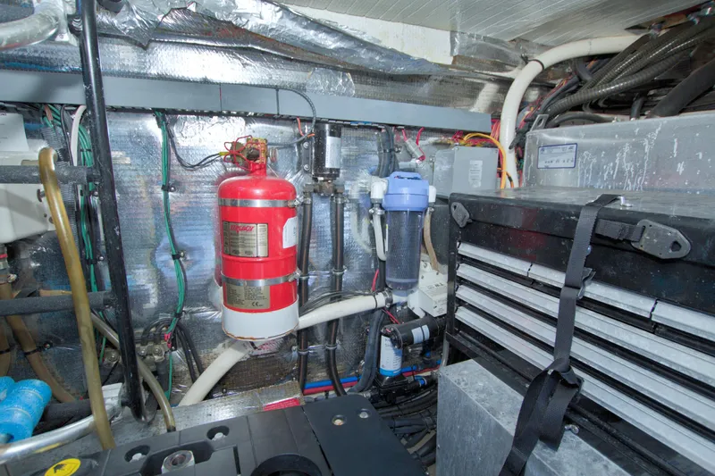 Serenity In The Sea Yacht Photos Pics Engine room of 2014 Regal 46 Sport Coupe with fire extinguisher and tool storage.