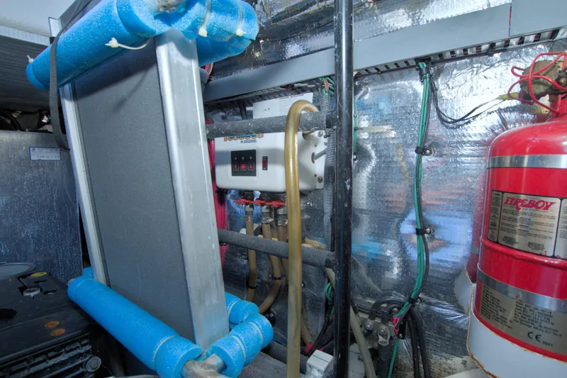 Serenity In The Sea Yacht Photos Pics Engine room of 2014 Regal 46 Sport Coupe with fire extinguisher and control panel.