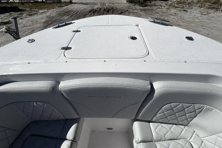  Yacht Photos Pics 2026 Southport 33 DC boat interior with white cushioned seating and deck.