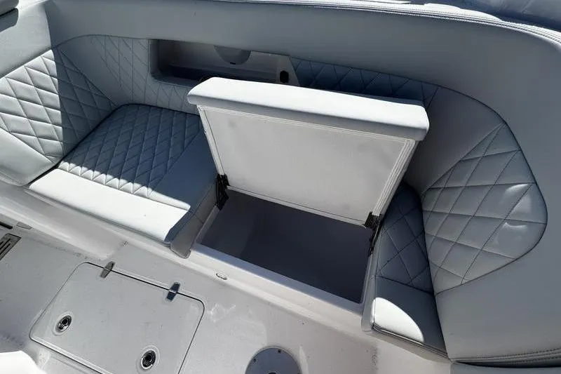  Yacht Photos Pics 2026 Southport 33 DC boat interior with open storage compartment and quilted seating.