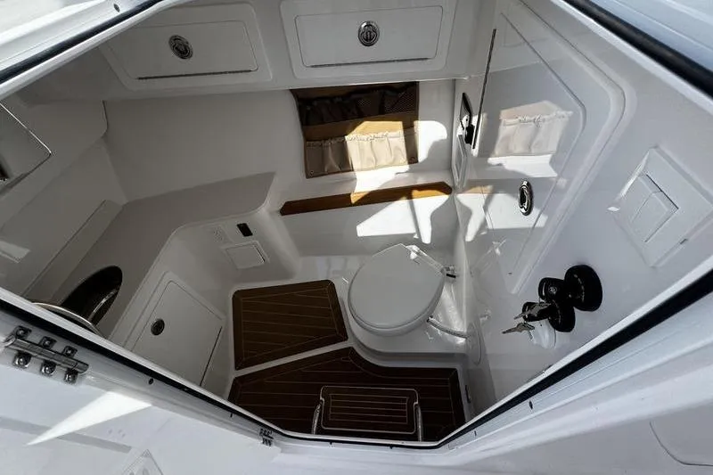  Yacht Photos Pics 2026 Southport 33 DC boat interior with modern bathroom amenities and wood accents.