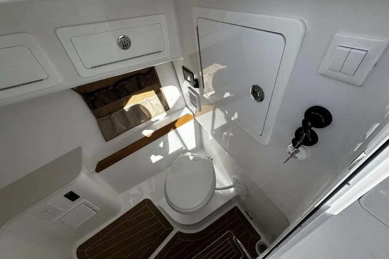  Yacht Photos Pics 2026 Southport 33 DC boat bathroom with modern fixtures and storage compartments.