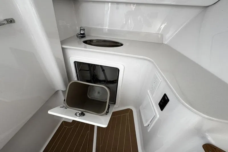  Yacht Photos Pics 2026 Southport 33 DC boat interior with sink and storage compartment.