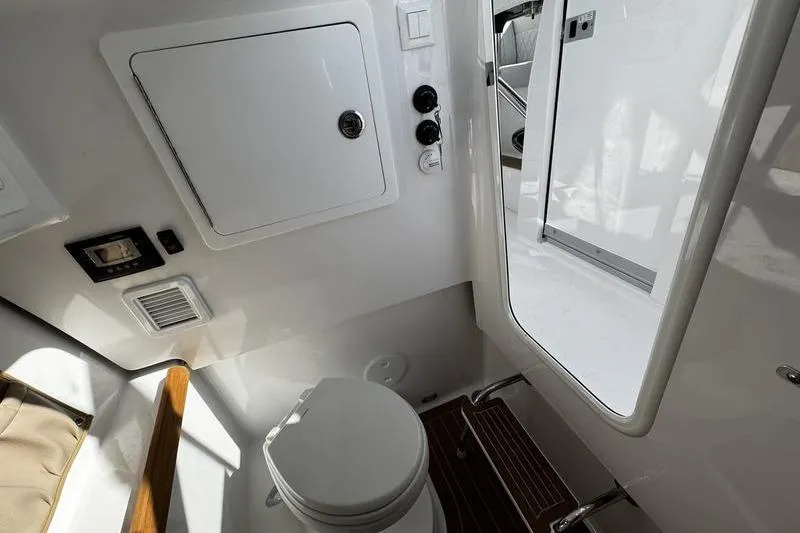  Yacht Photos Pics 2026 Southport 33 DC boat interior with compact bathroom and modern fixtures.