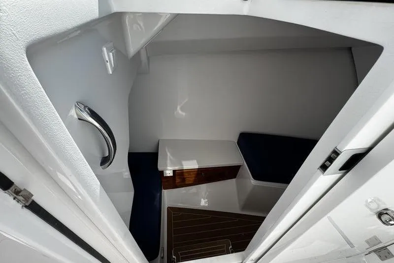  Yacht Photos Pics Interior cabin of 2026 Southport 33 DC boat with seating and wooden accents.