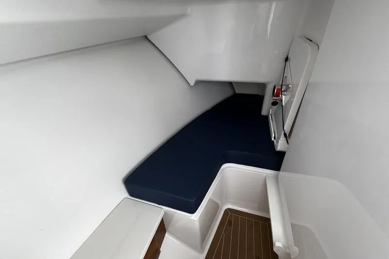  Yacht Photos Pics 2026 Southport 33 DC cabin interior with blue seating and wooden flooring.