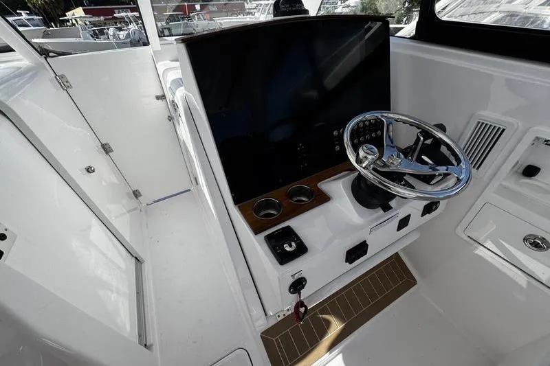  Yacht Photos Pics 2026 Southport 33 DC boat helm with modern steering and control panel.