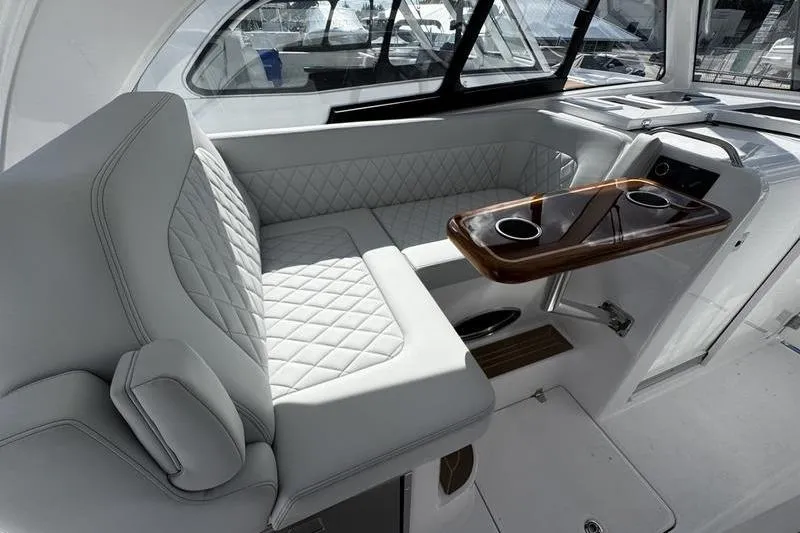  Yacht Photos Pics Luxurious interior of 2026 Southport 33 DC boat with plush seating and elegant table.