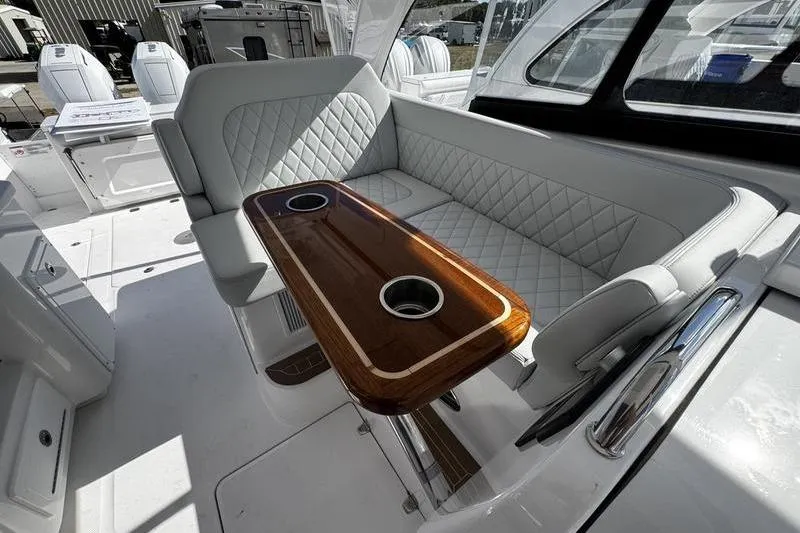  Yacht Photos Pics Luxurious interior of 2026 Southport 33 DC boat with elegant seating and wooden table.