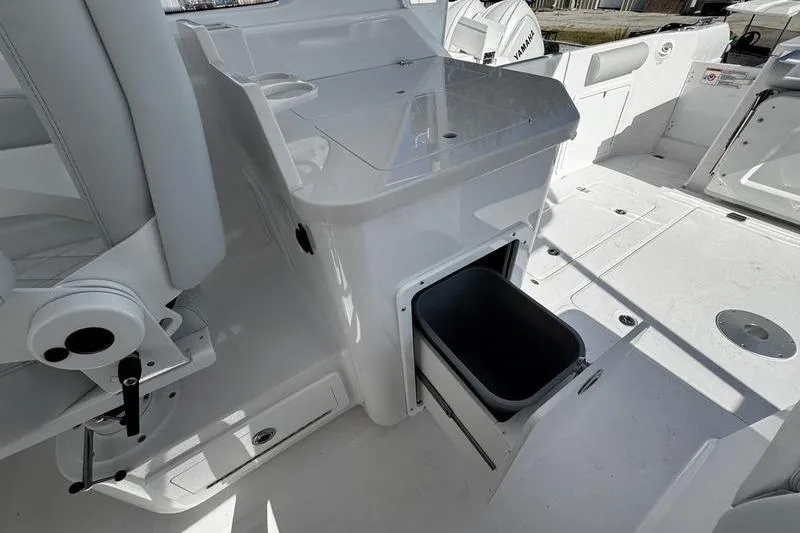  Yacht Photos Pics 2026 Southport 33 DC boat interior with storage compartment and seating area.