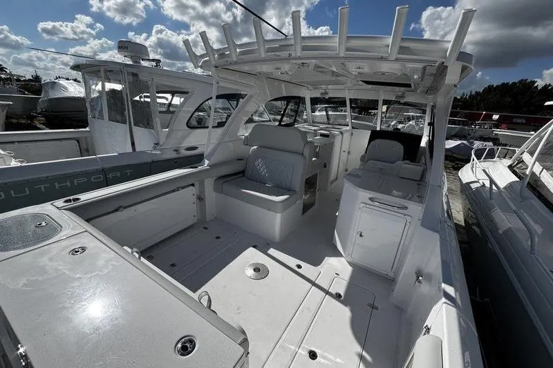  Yacht Photos Pics 2026 Southport 33 DC boat interior with seating and storage under a cloudy sky.