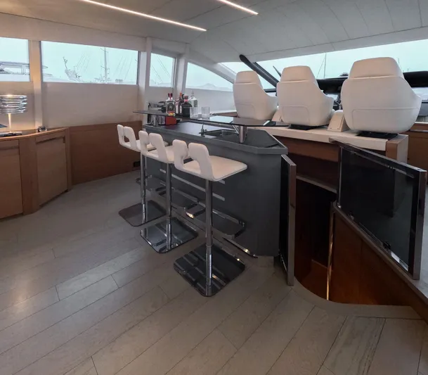  Yacht Photos Pics Luxurious interior of 2012 Pershing 92 yacht with sleek bar and modern seating.